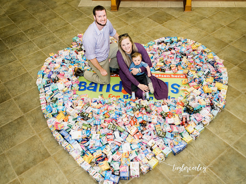 Mark and Paige Welch and son Jack show some of the many Band-Aids collected through their Band-Aids for Batson campaign. (Photo courtesy of Taylor Cooley Photography)